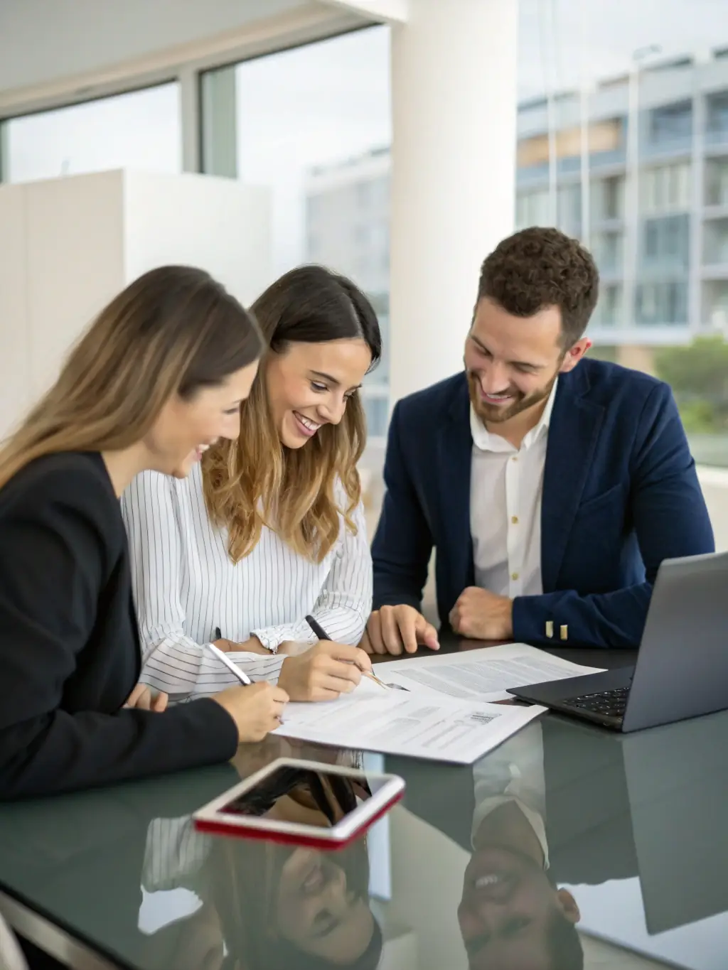 A couple signing legal documents with an attorney present, illustrating the process of property division in a divorce case.
